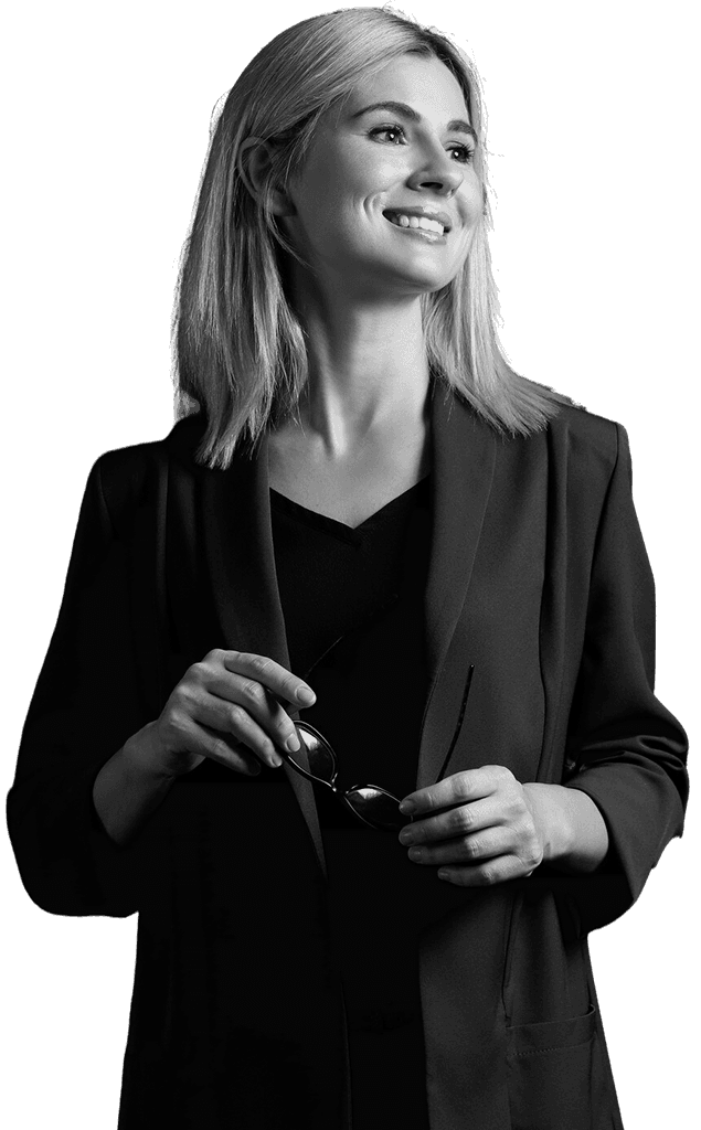 Professional woman in a suit standing in an office setting.