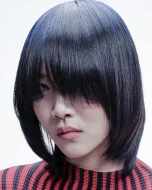 A model with short straight blue hair.