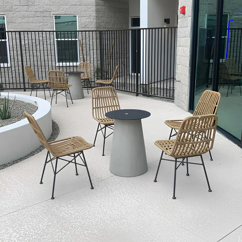 Modern outdoor woven chairs and round pedestal table on a contemporary patio.