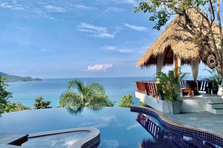 sunloungers fronting buildings near mountain