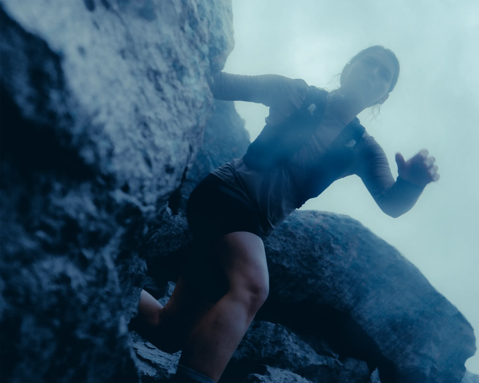 dynamic picture of a woman trail running.