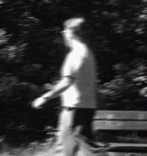 A photo of a designer walking in the park