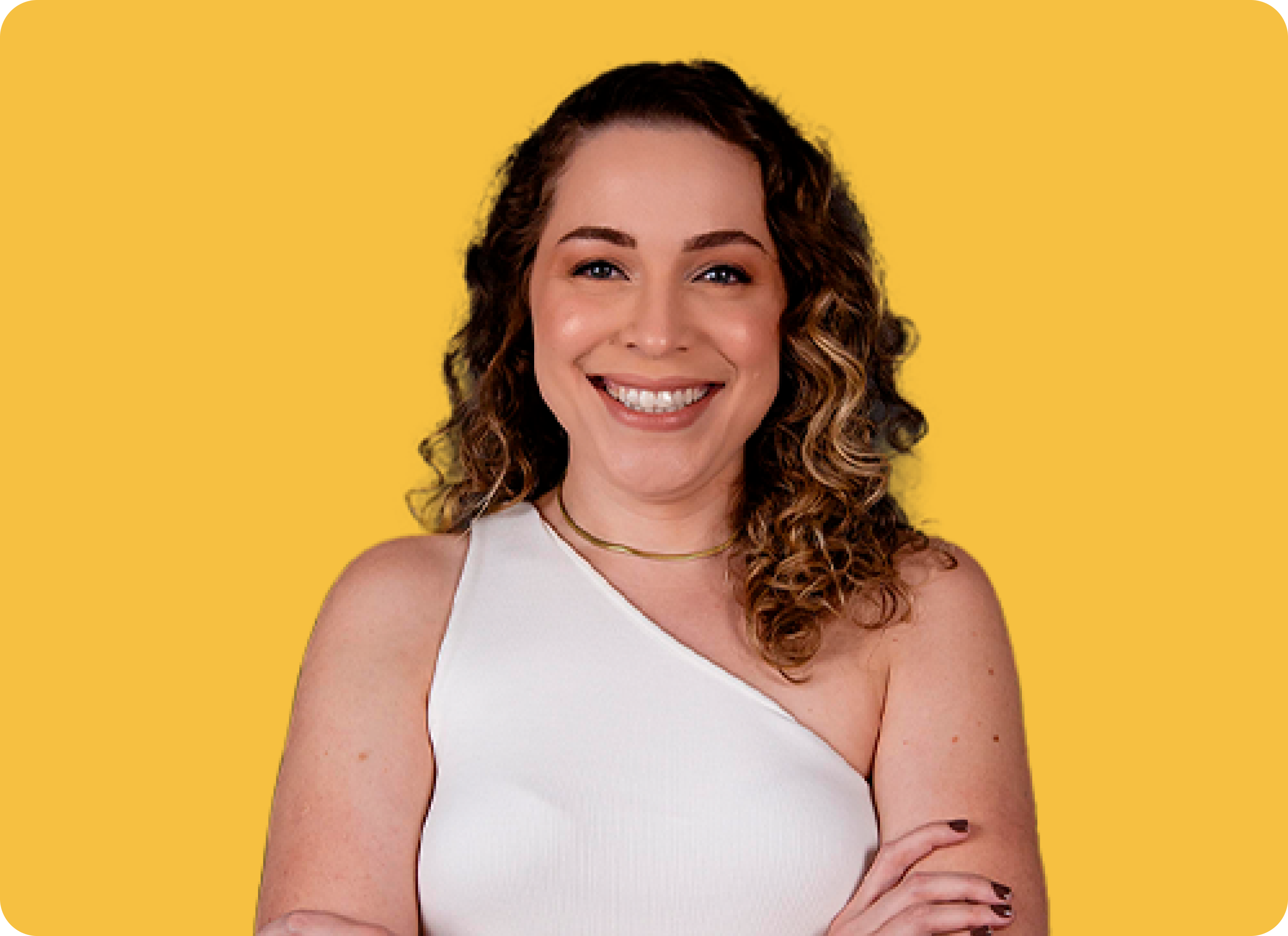 A winding road cuts through rocky terrain, surrounded by patches of green grass and illuminated by sunlight.