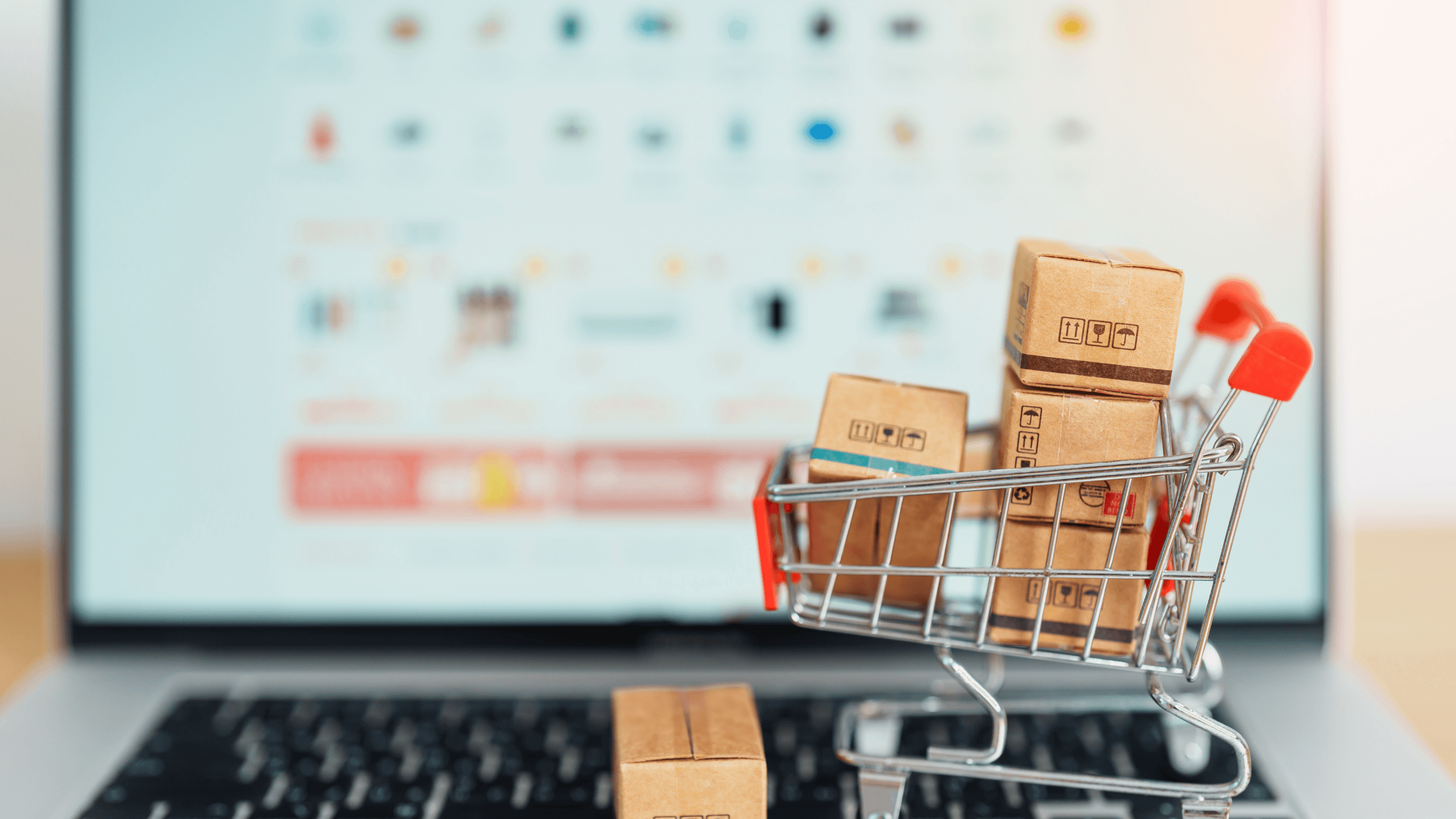 Computer and shopping cart representing black friday 2024 online shopping