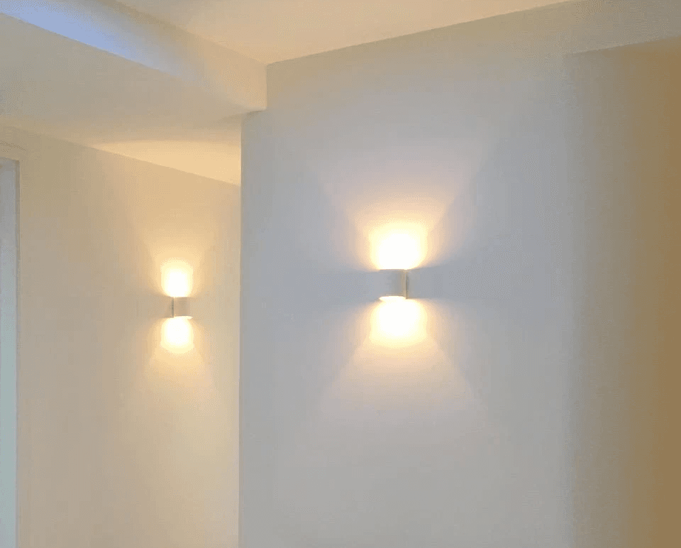 a pregnant woman laying on a bed covered in a blanket