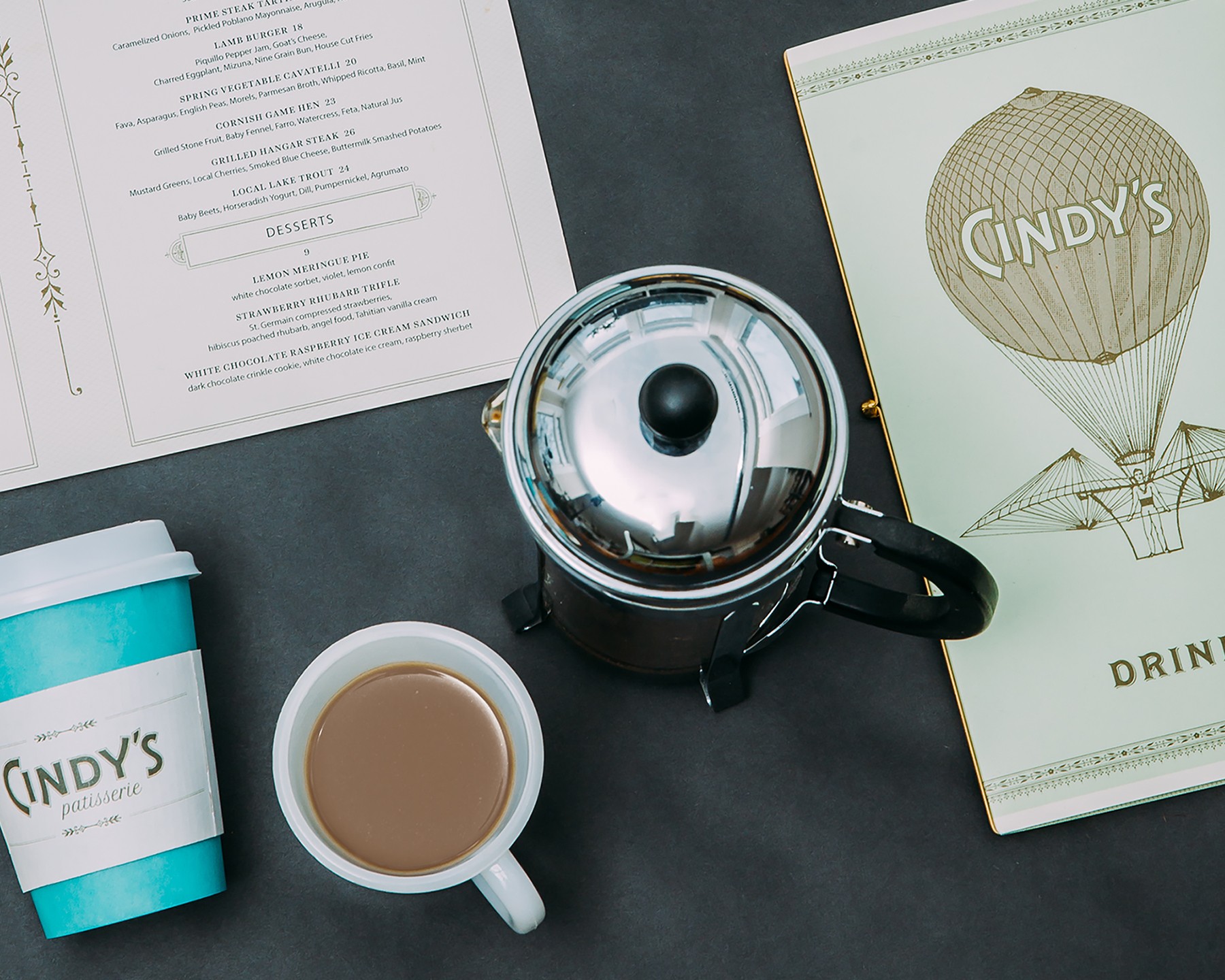 Detail shot of menu cover, coffee sleeve, and menu page