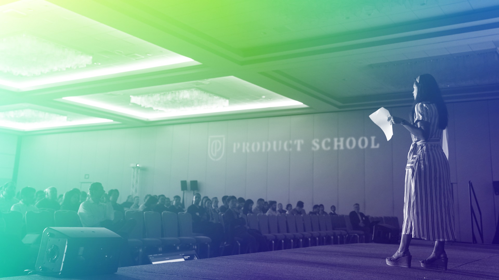 female public speaker on stage