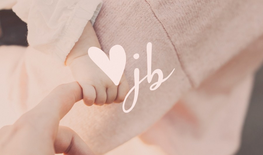 baby hand holding parent's finger