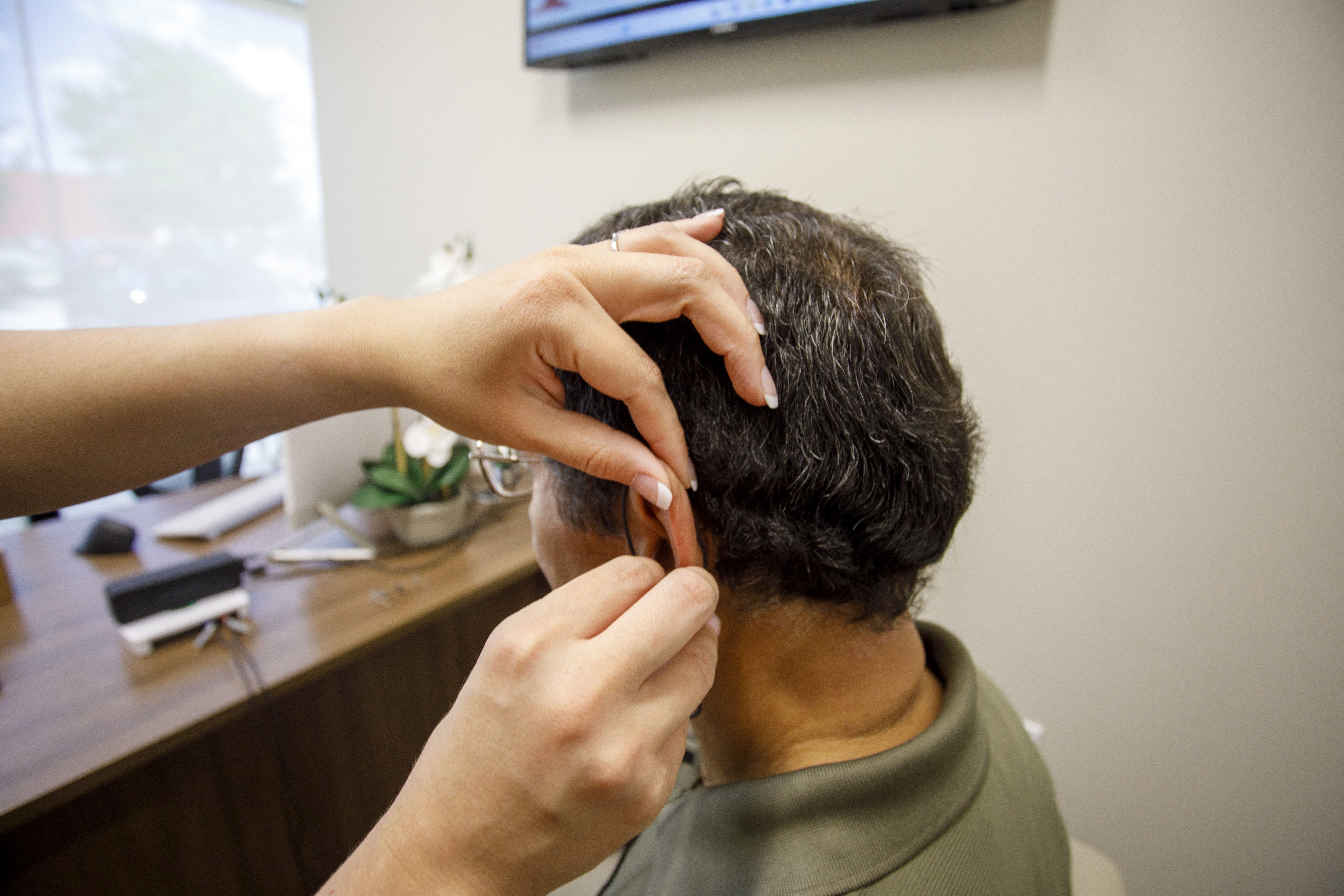 A patient having a hearing aid fitted
