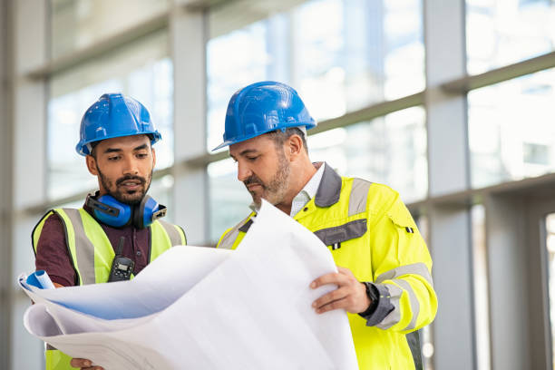Construction workers reviewing blueprints