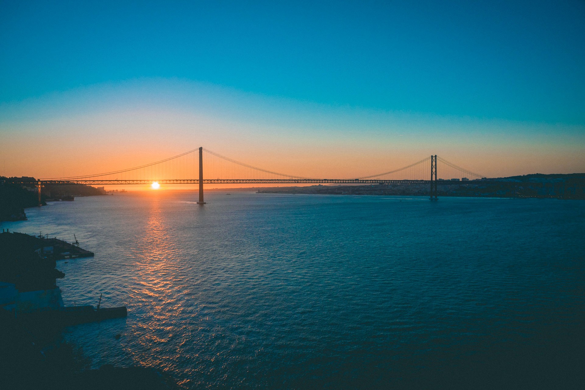 Fine art landscape photography of the sunset happening behind a bridge