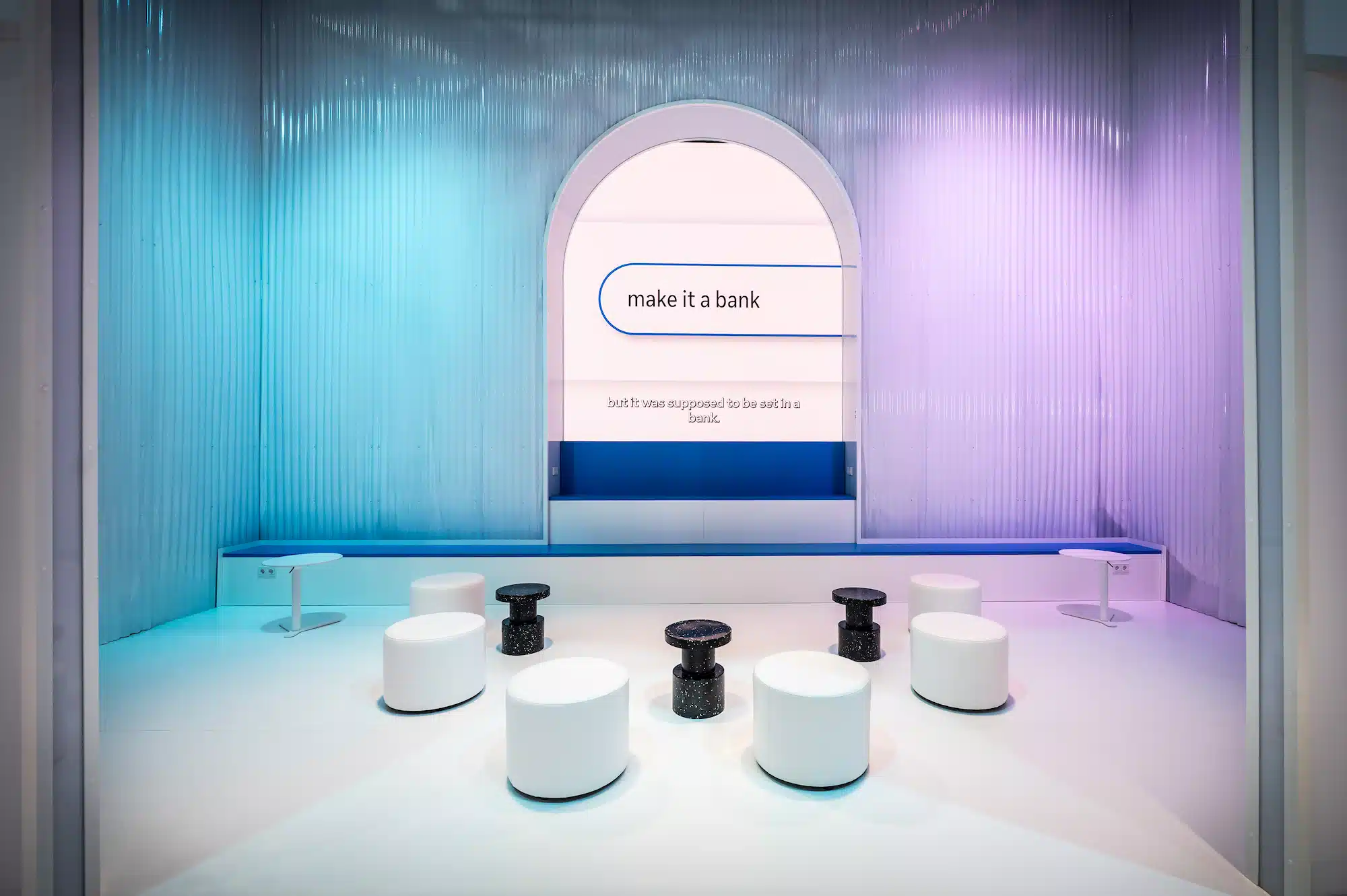 Meta – lounge area of the trade show booth with turquoise-blue arch architecture and modern seating design