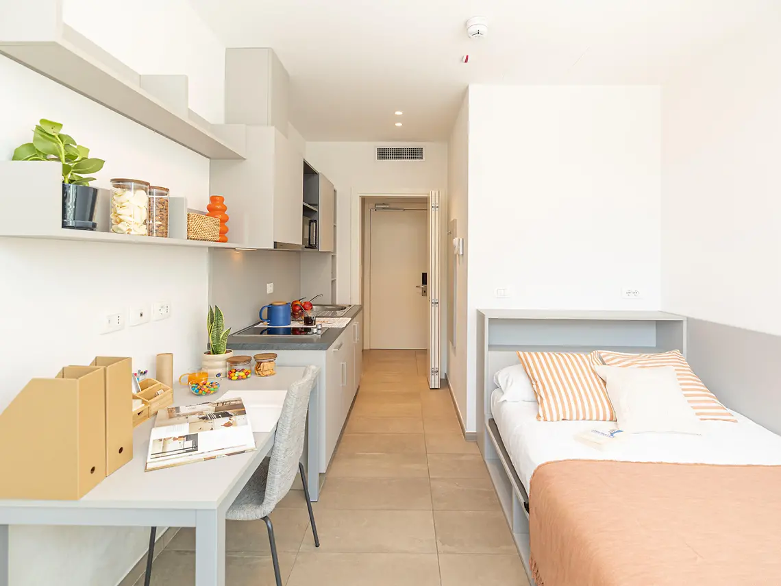 Compact smart studio with single bed, kitchenette and study desk at Florentia Living, Florence