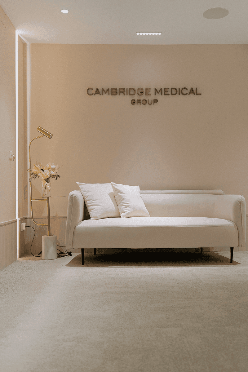 Modern waiting room with couch and throw pillows.