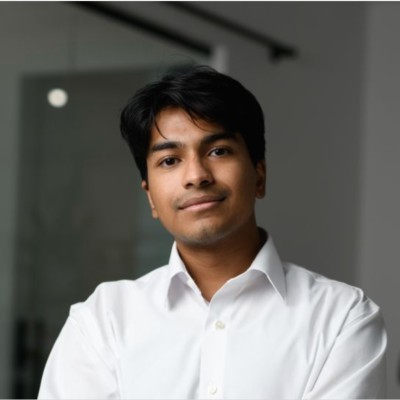 A young male author with dark hair and a white collared shirt, looking confidently at the viewer, representing a digital.