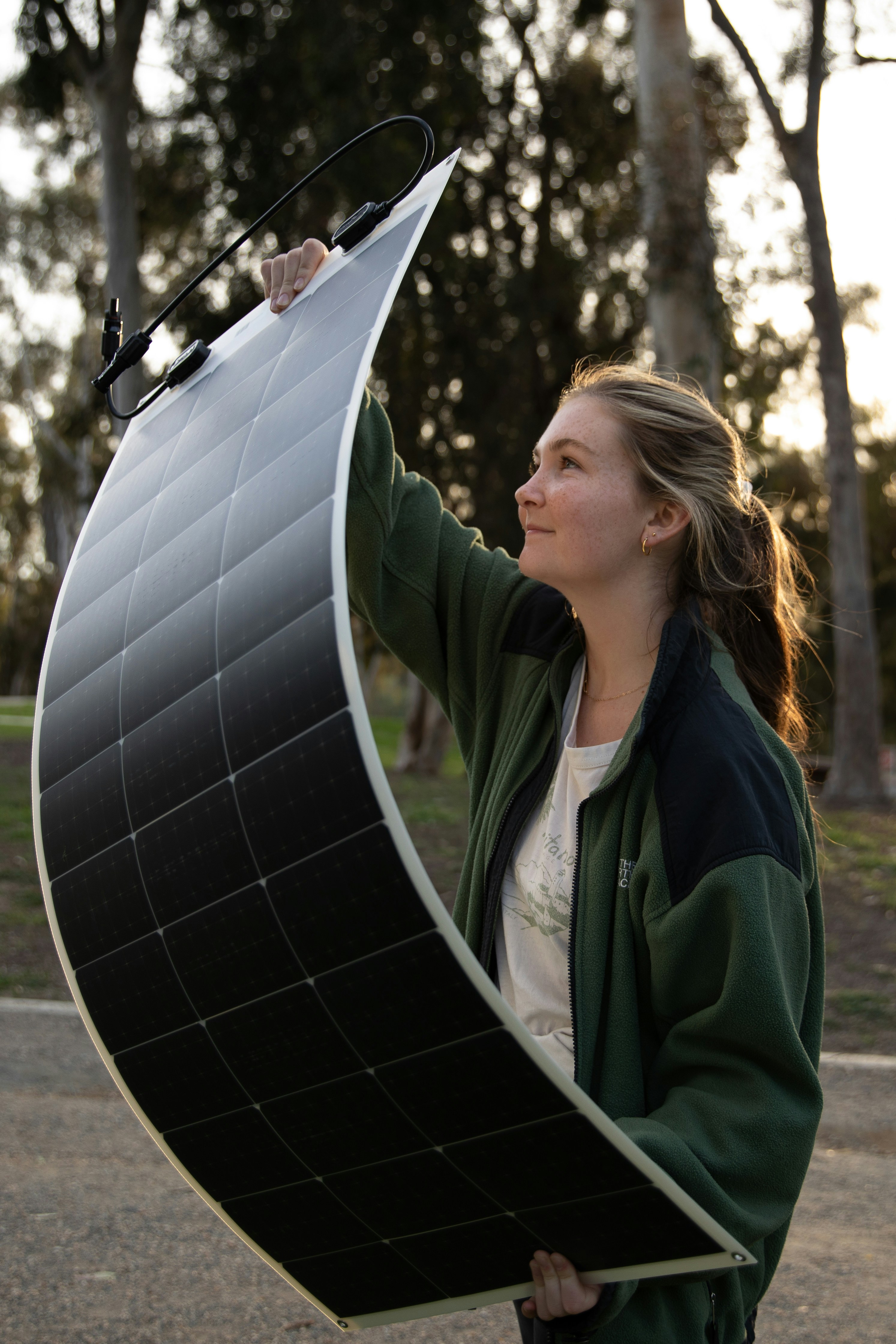 a woman holding a solar panel in her hands