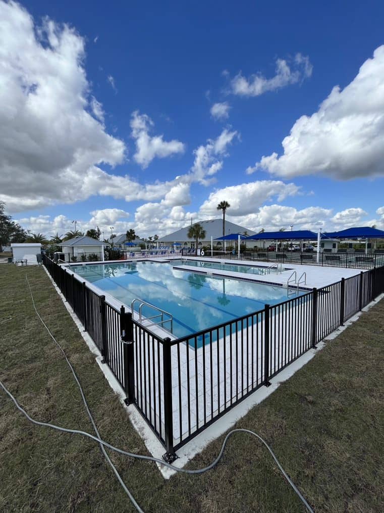 Image of commerical community pool with gated enclosure surrounding the premises