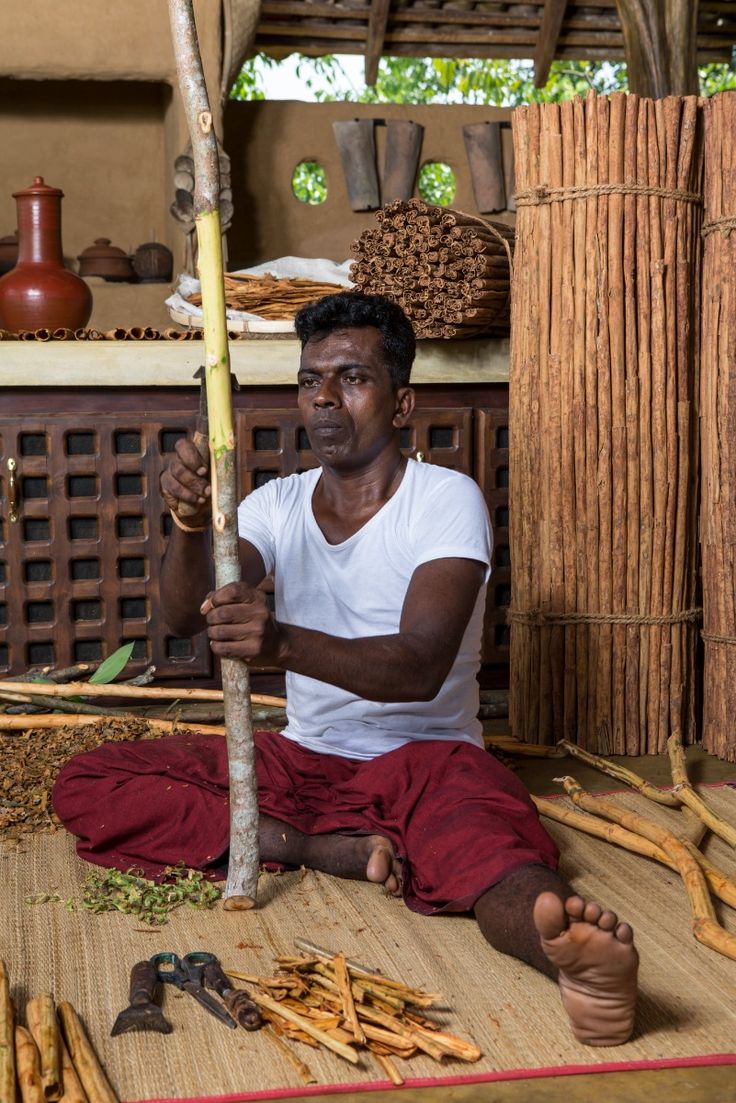 A man playing a drum in front of a group of people