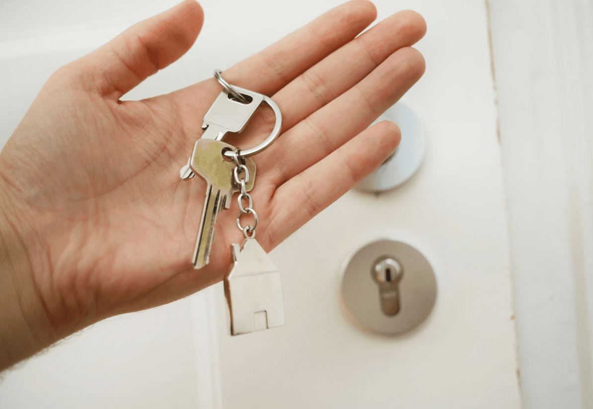 Keys to a house held by a man