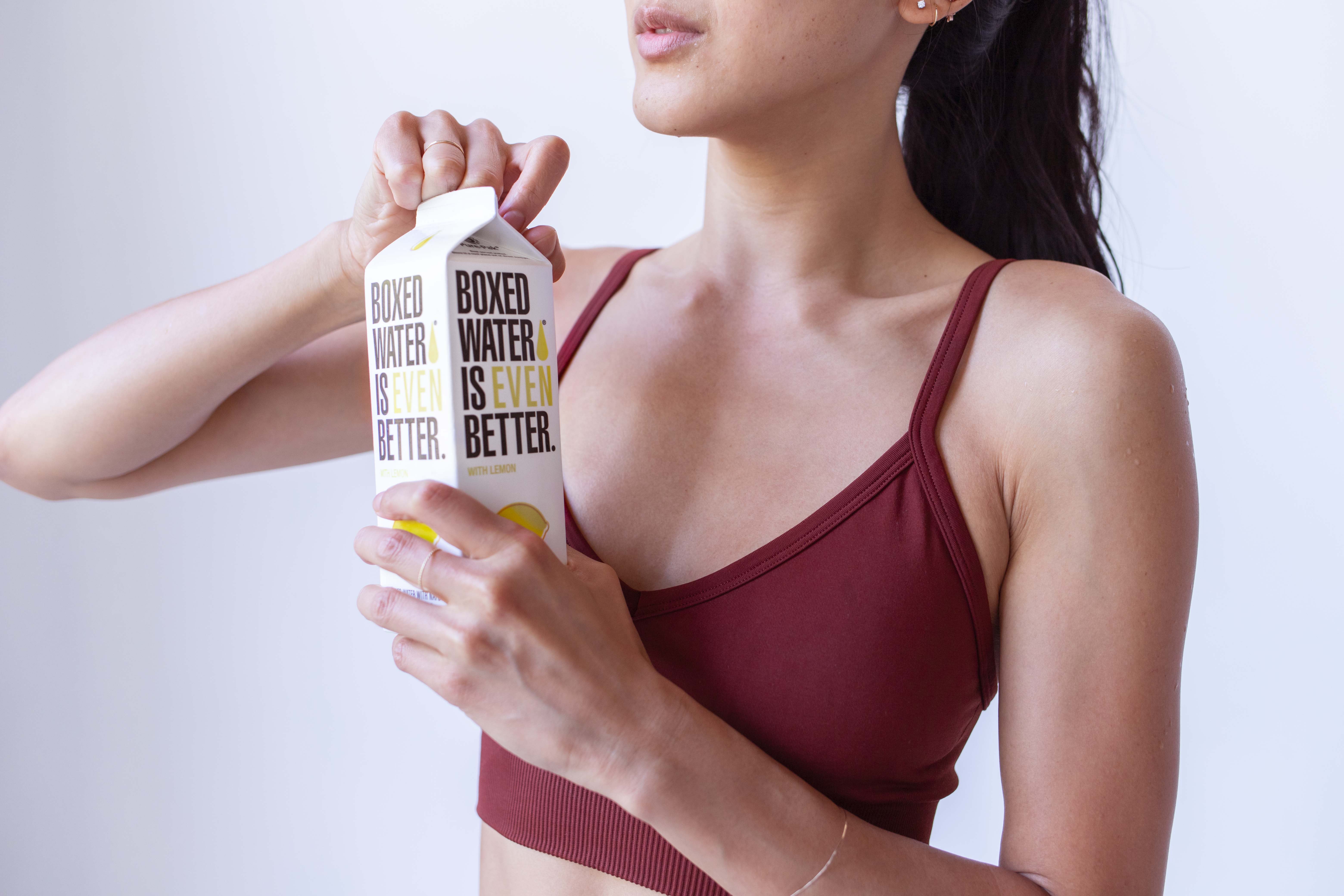 Woman opening boxed water