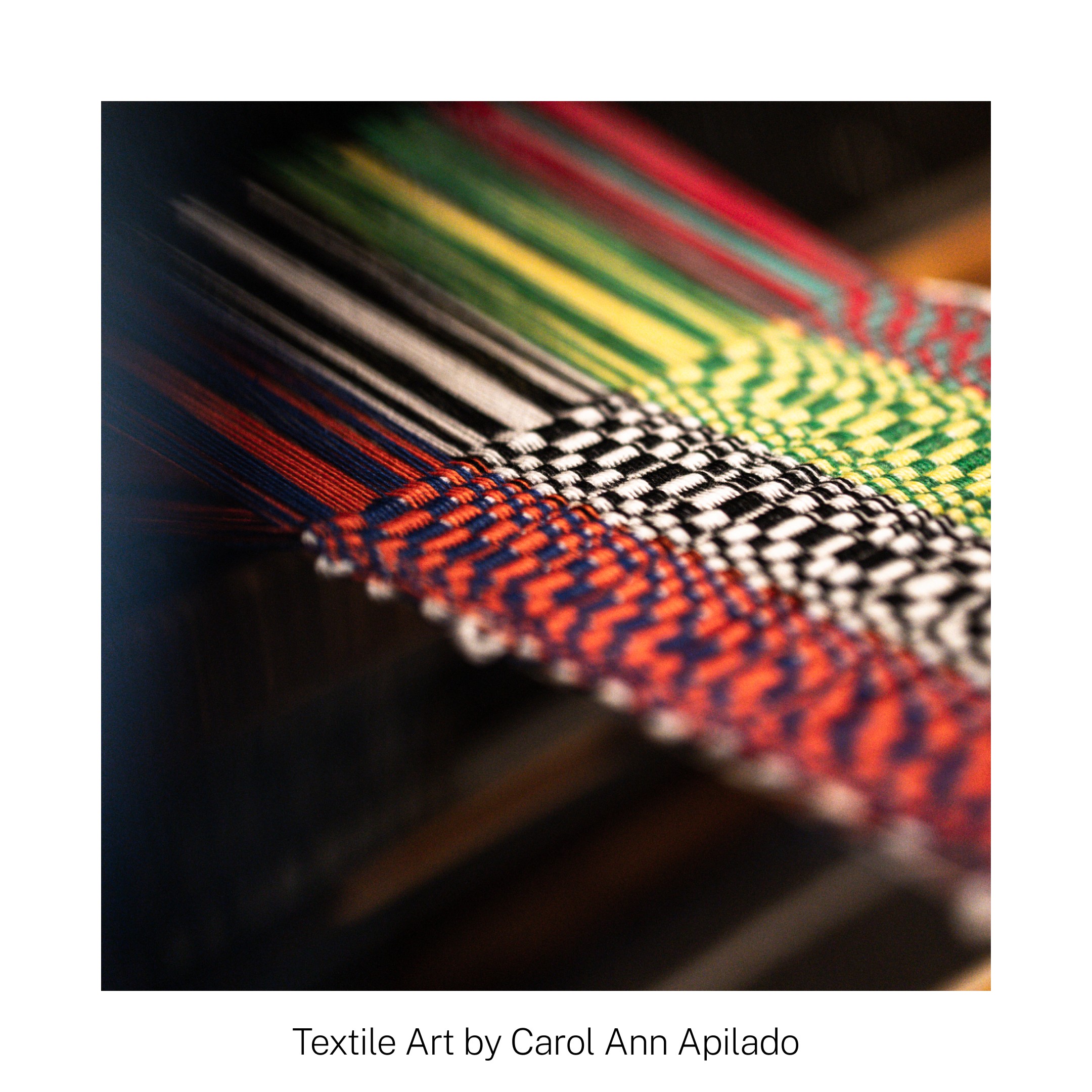 Colorful woven fabric on a loom, showcasing intricate patterns in red, green, black, and white threads.