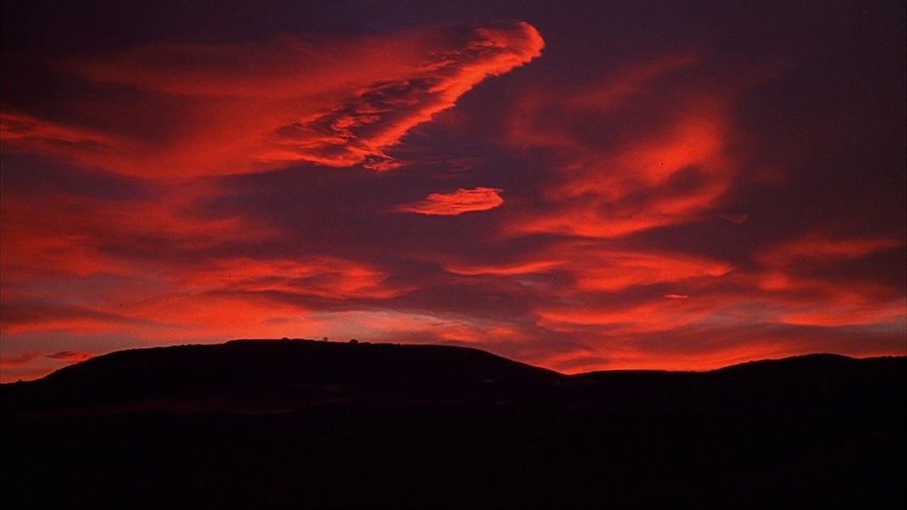 A rustic dining room with wooden table and chairs.