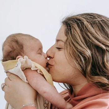 mother kissing baby