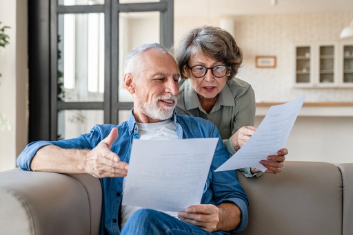 two people reading paper exams