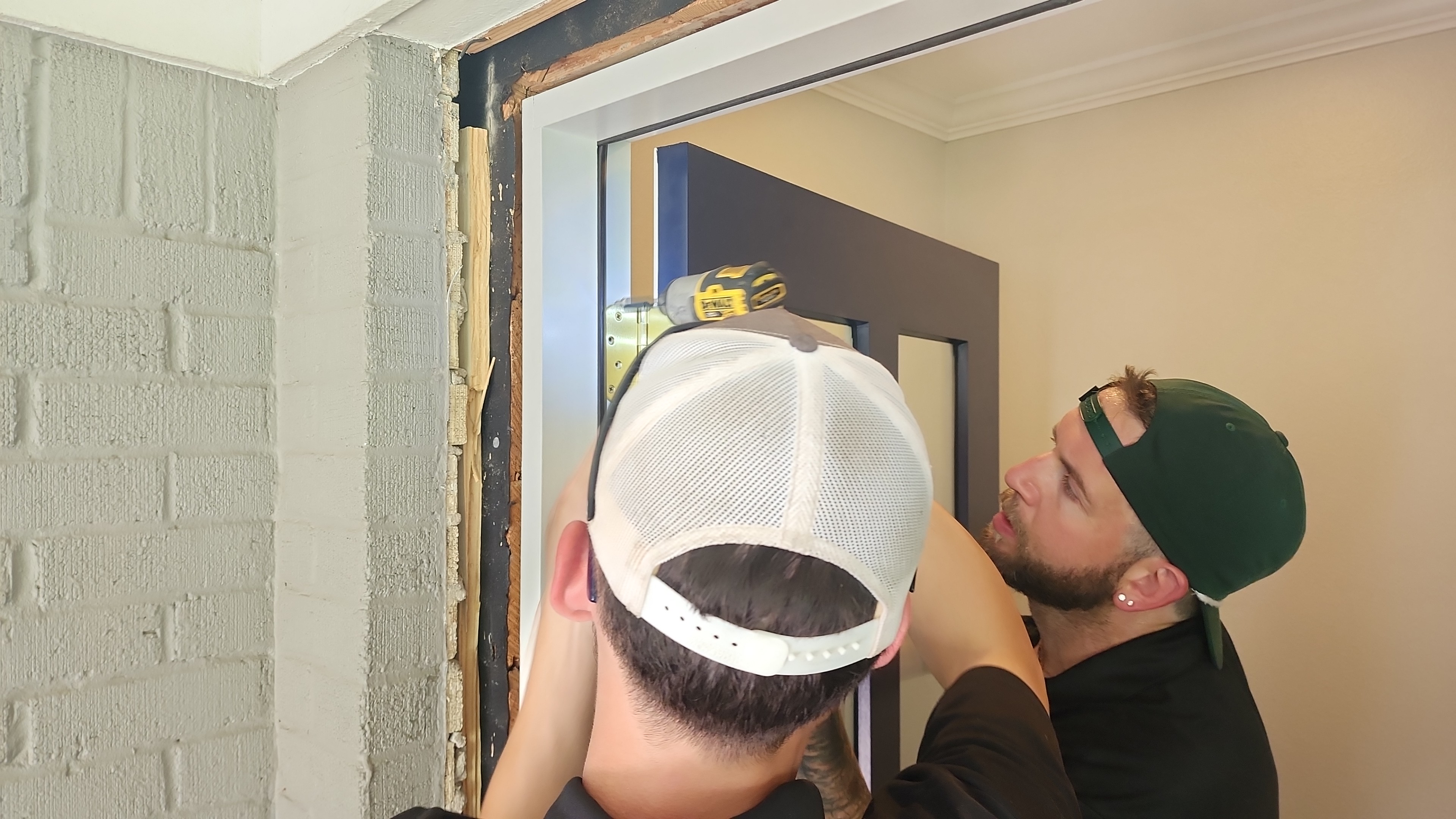 Your New Door technicians working on the calibration of a door hinge while on a door replacement job in Highland Park area of Dallas, TX
