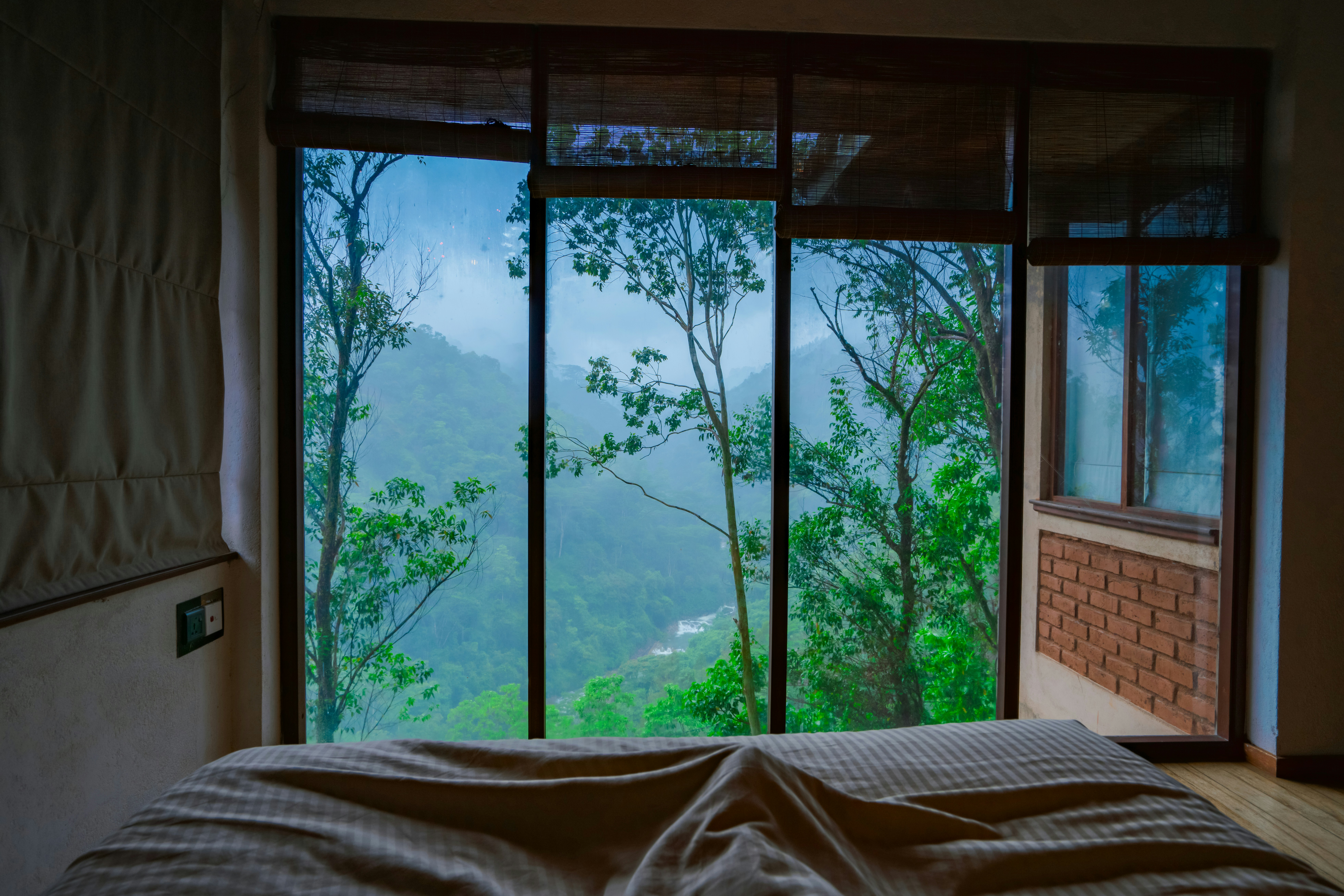 a bedroom with a view of the mountains outside the window