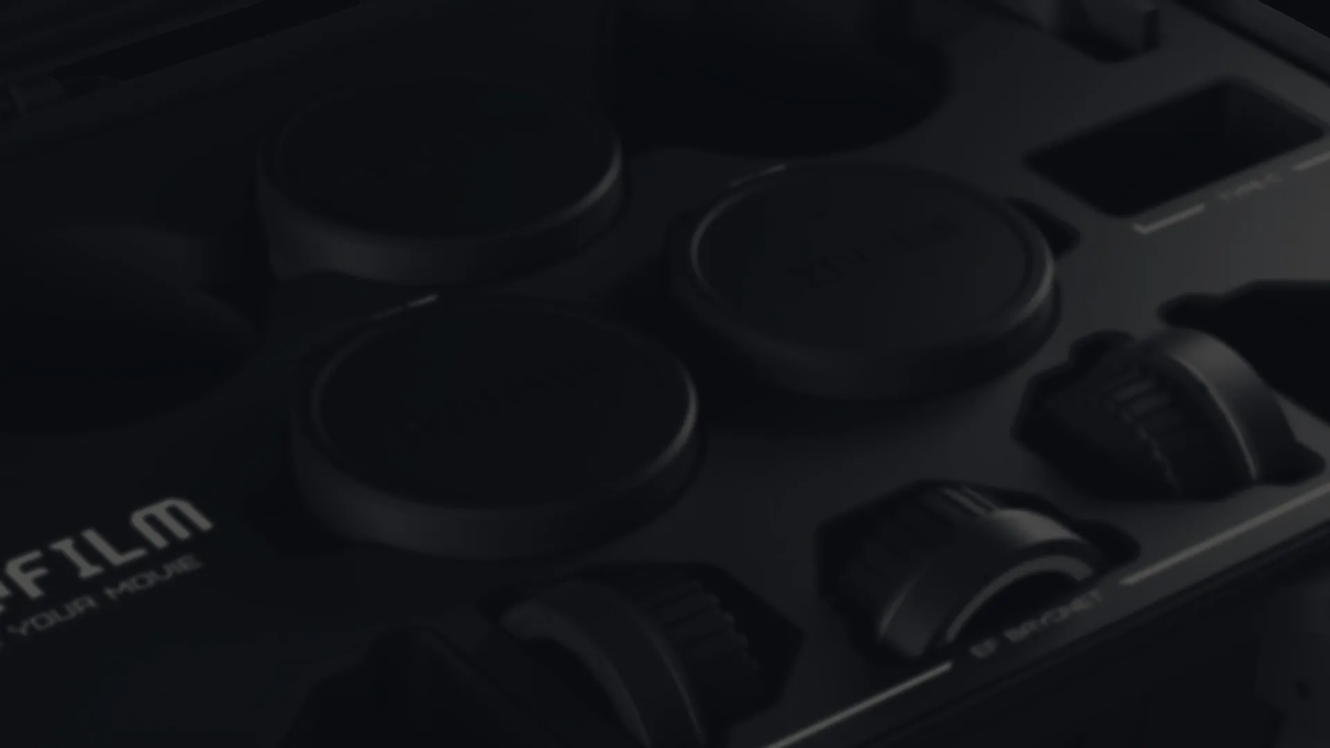 Close-up of camera buttons and dials, monochrome.