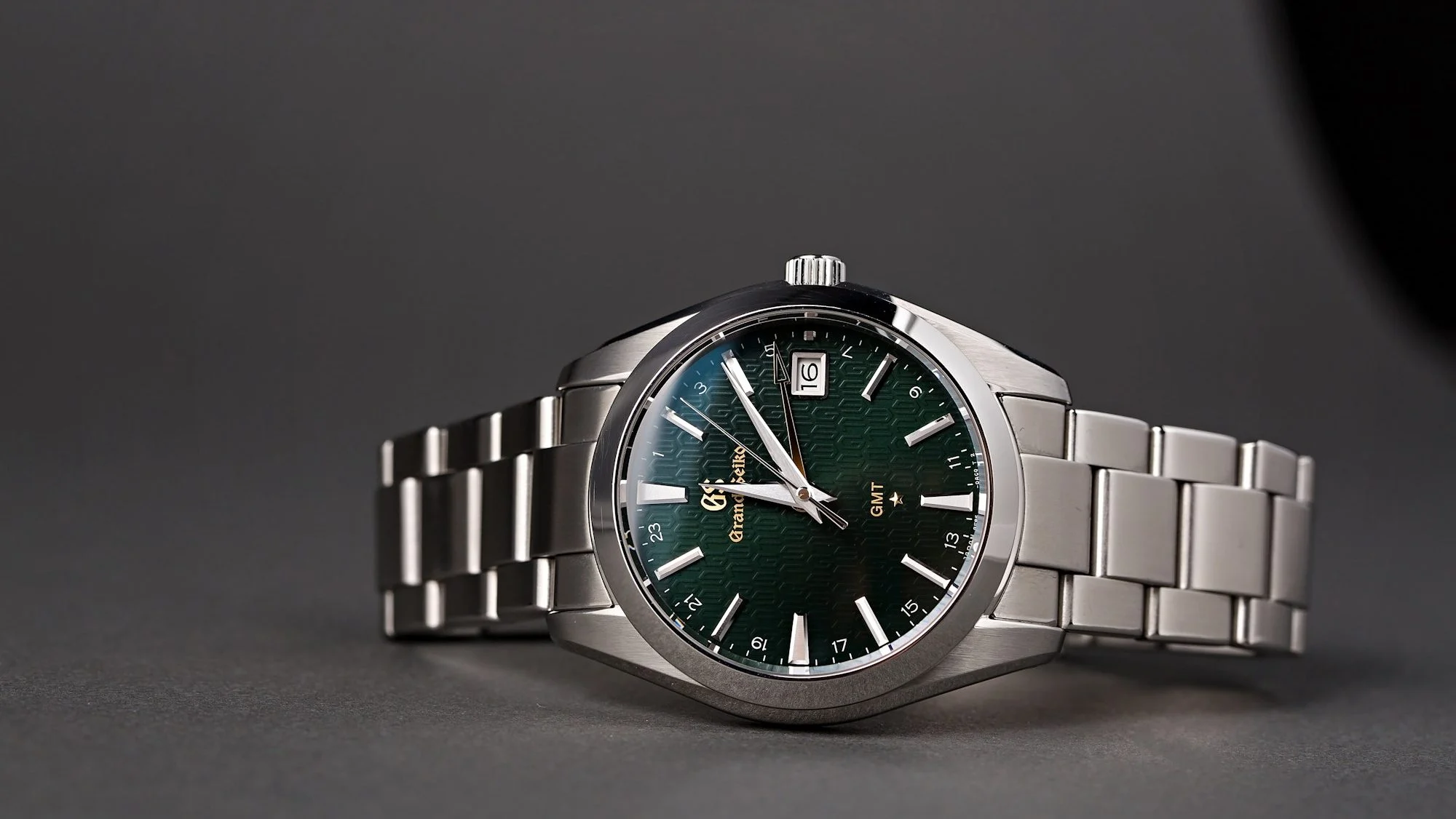 Grand Seiko watch with green dial and stainless steel bracelet