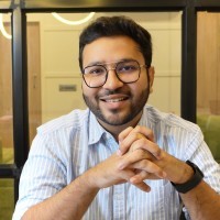 man in white crew neck shirt wearing black framed eyeglasses