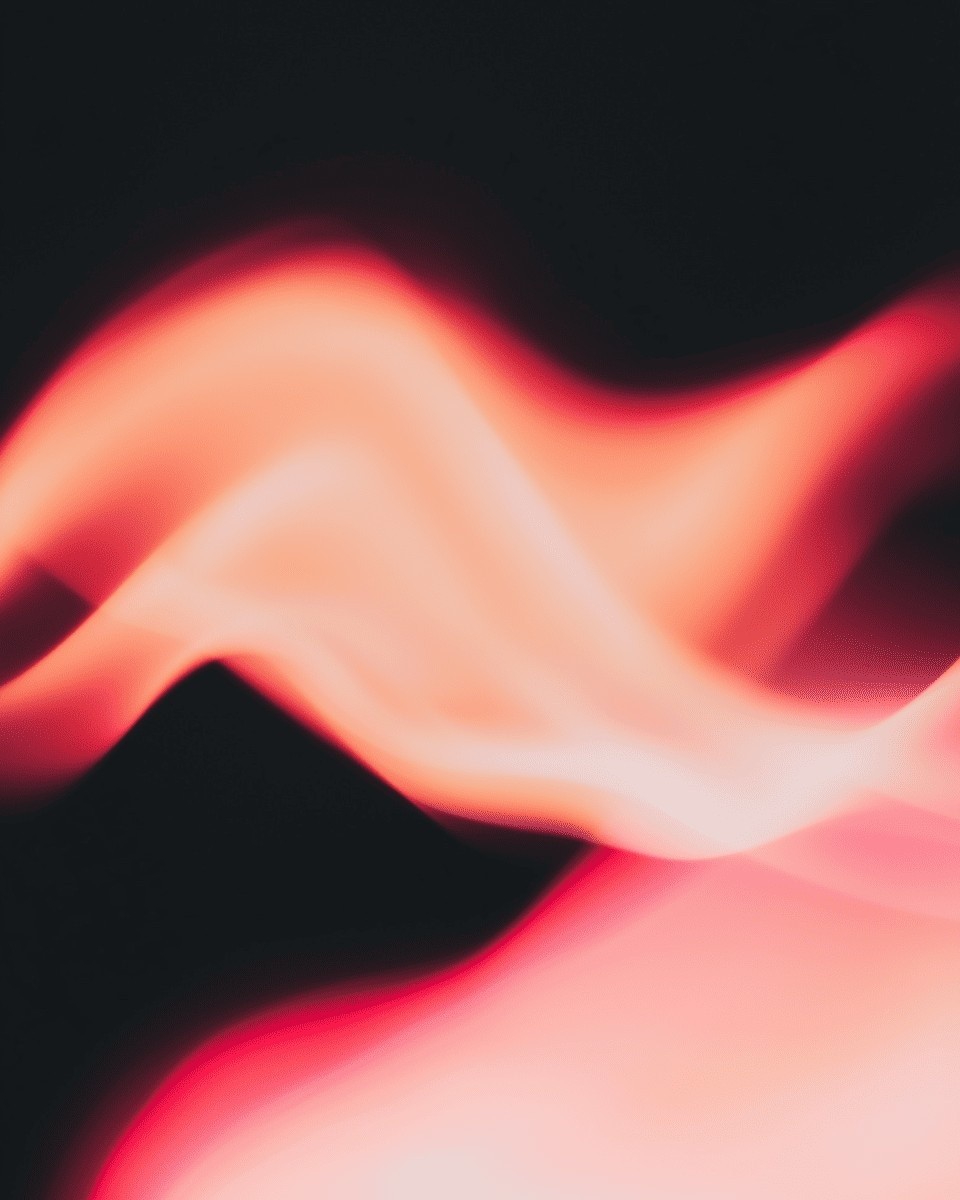 A vibrant display of red and pink abstract light waves gracefully swirl against a dark background, creating a dynamic and visually striking composition.