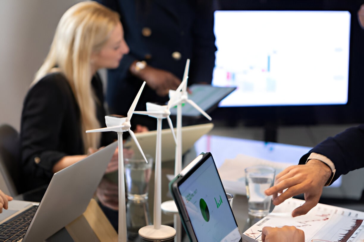 A man indicates a screen during a work meeting