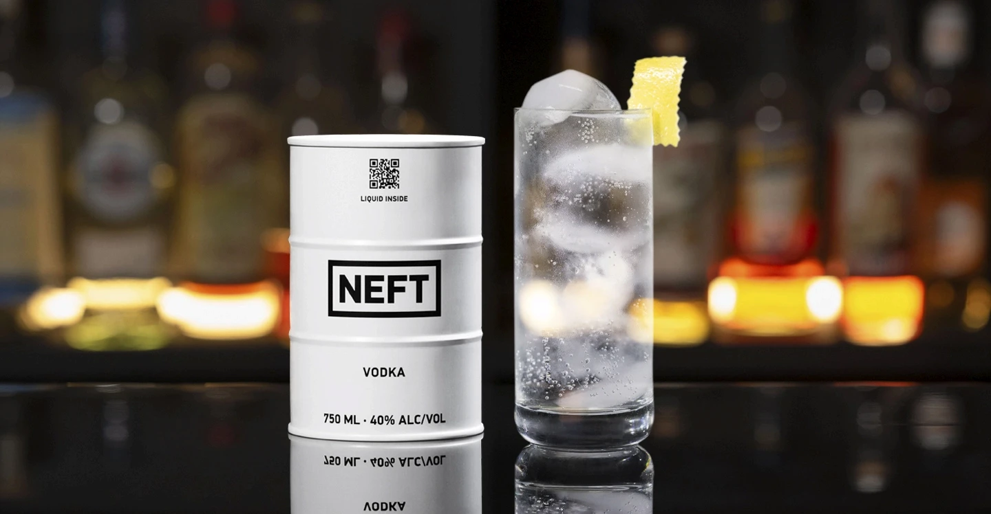 A NEFT Barrel and a glass of Vodka Tonic on a bar counter.