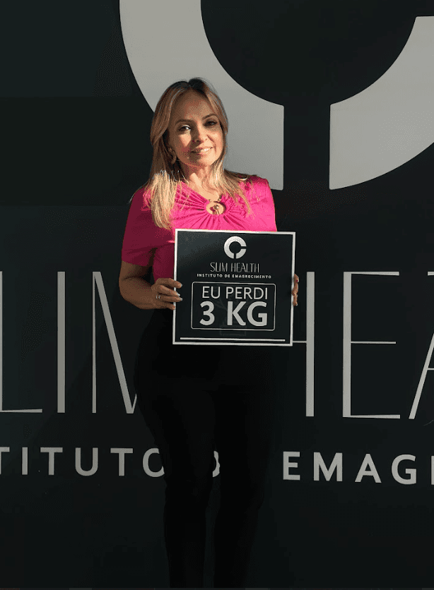 Close-up of a dark green leaf showing its textured surface and central vein against a muted background.