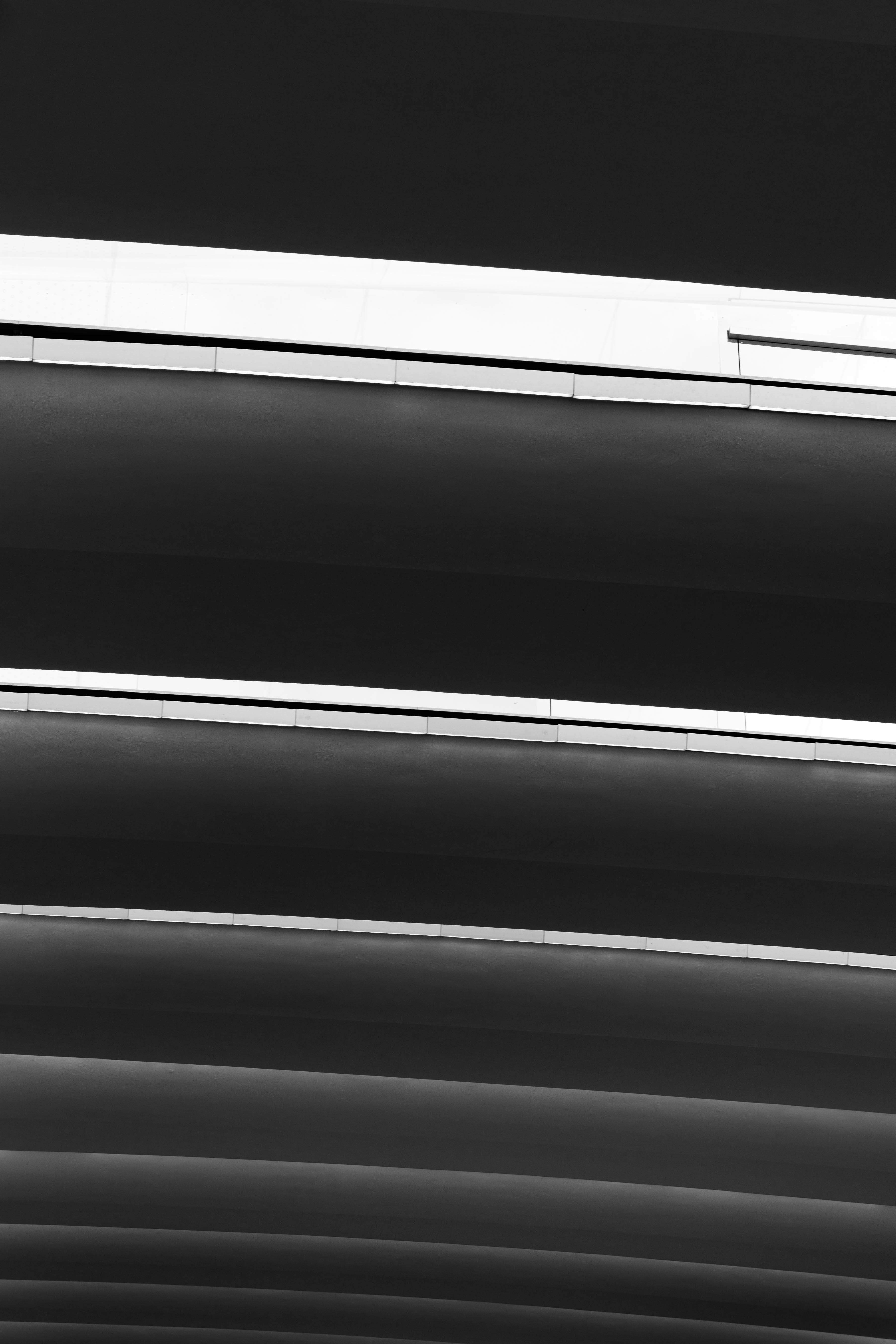 a black and white photo of a window with blinds