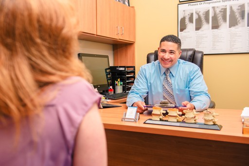 dr elliot cintron listening to a female patient