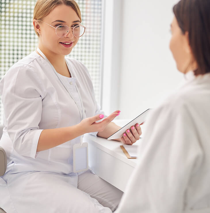 Healthcare professional speaking with a patient during a consultation