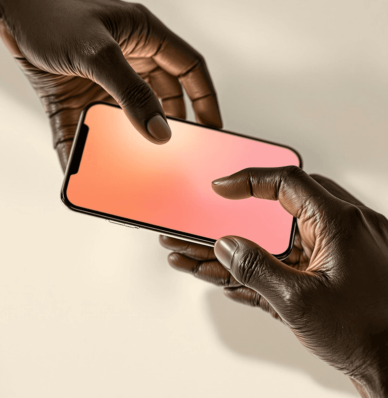 Close-up of hands holding a smartphone with a gradient pink screen.