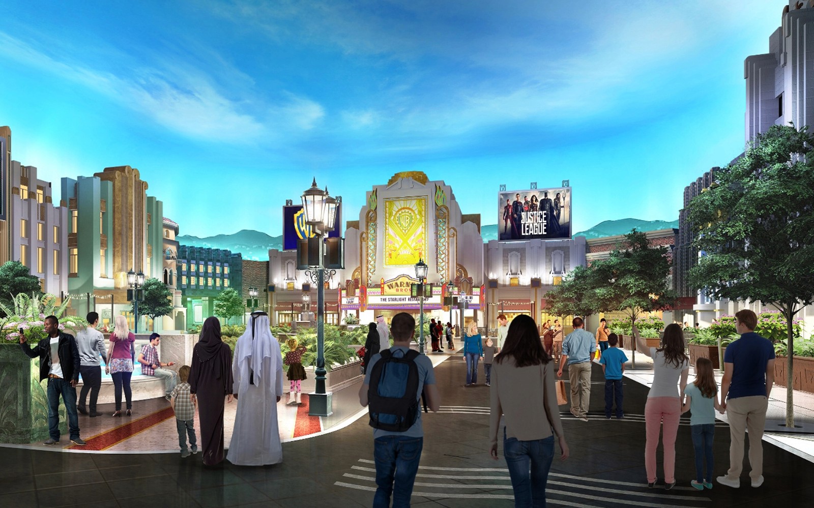 Visitors walking through Warner Bros. World Abu Dhabi with themed buildings and Justice League sign.