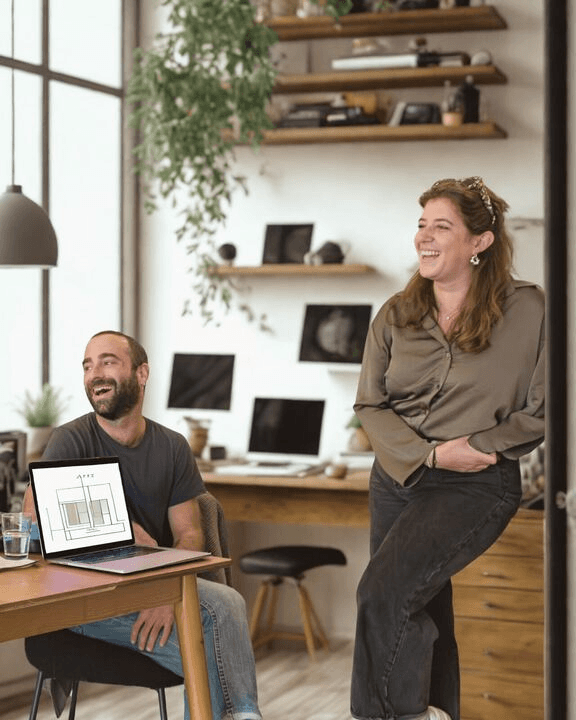 A group of three confident real estate professionals in formal business attire standing with arms crossed, representing Vistaires’ team
