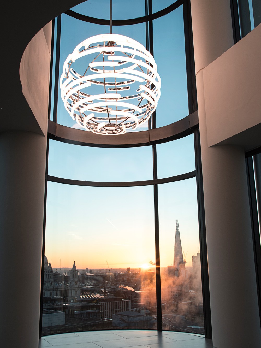 Deloitte Orb – large suspended light with curved opal acrylic and chrome finish