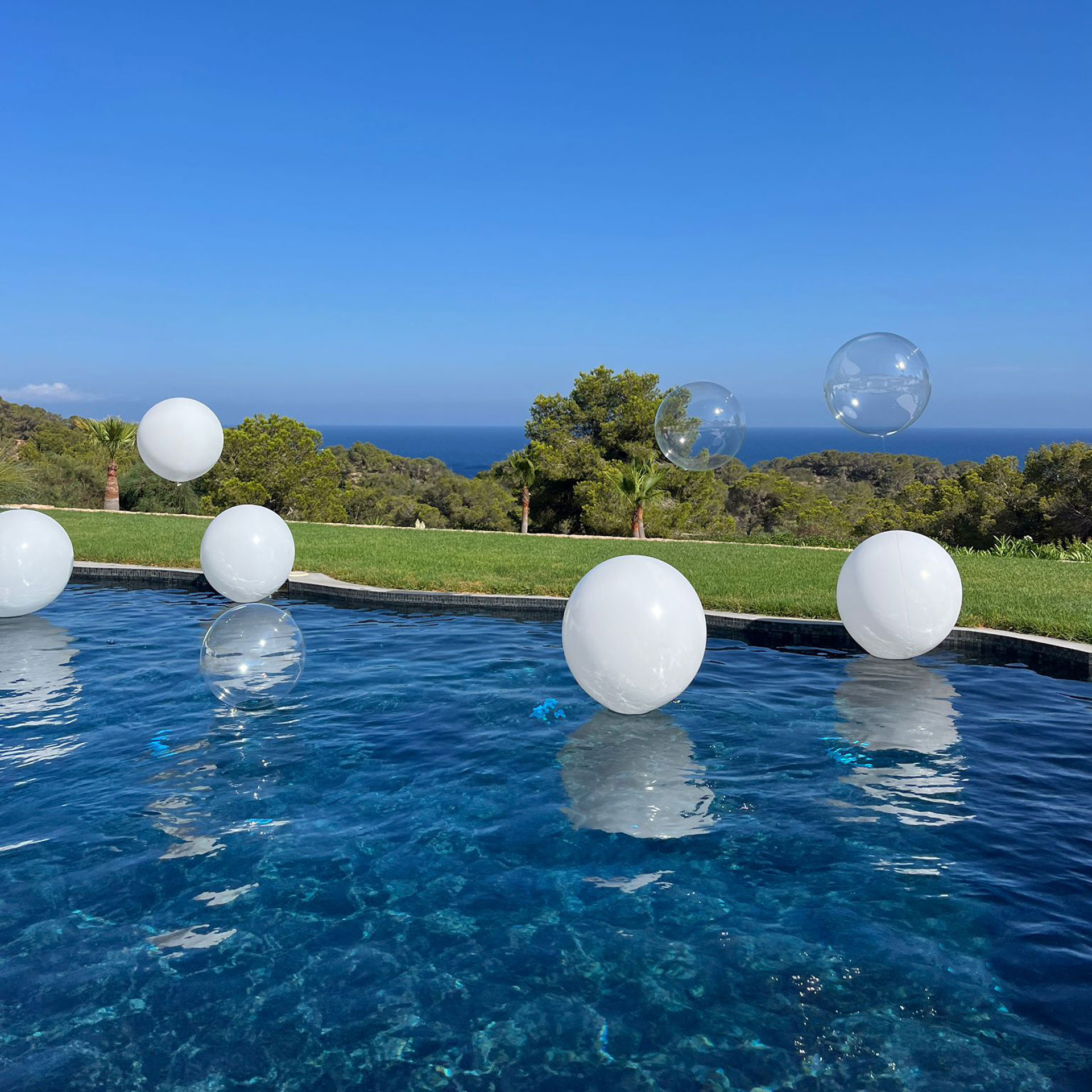 White balloons at pool, exclusive luxury villa Ibiza events holiday retreat.