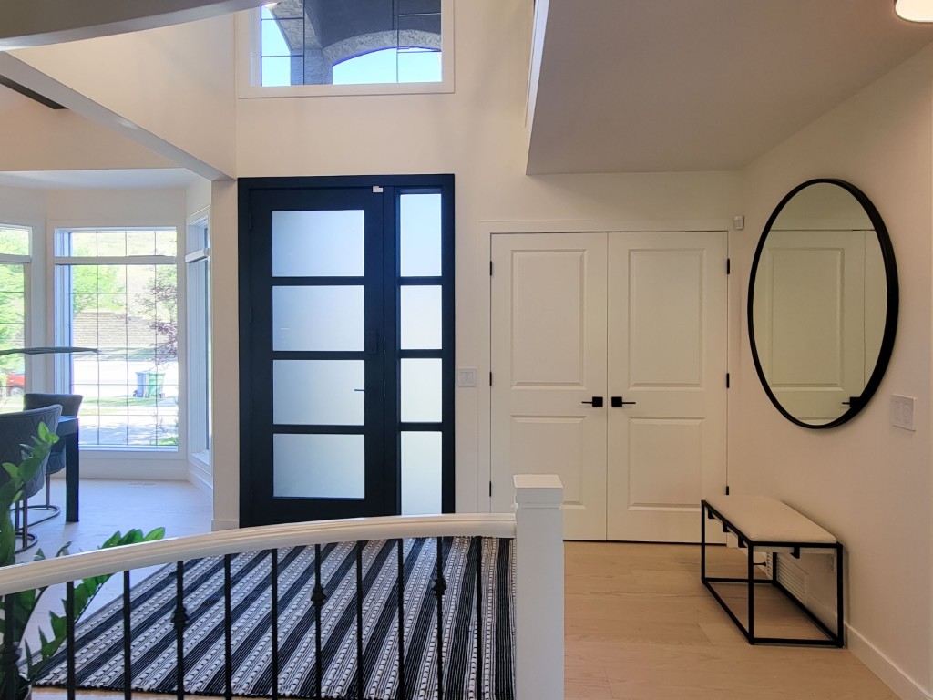 Image of Elegant entryway with modern design, furniture, and window coverings by KHD Homes showcasing interior design expertise.
