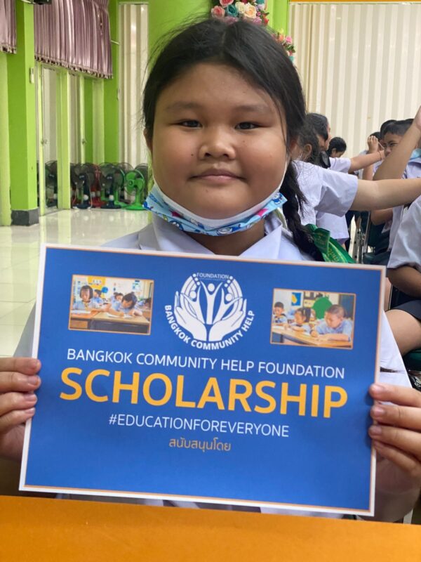 two young boys brushing their teeth in front of a crowd