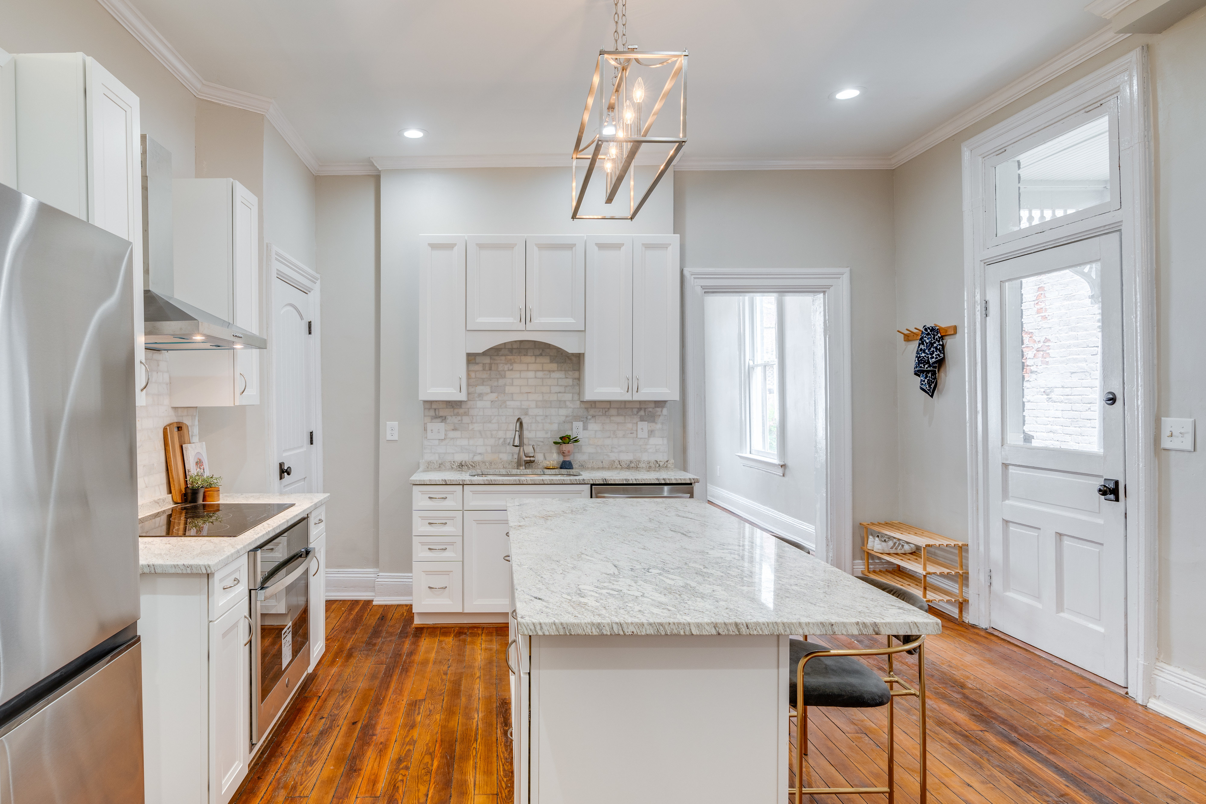 A man riding a bike down a street next to a trash can