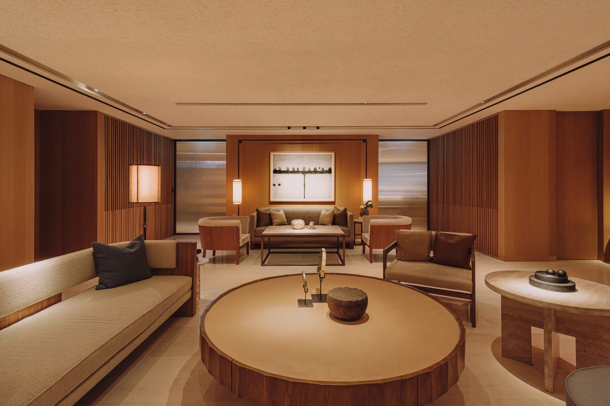 A long bench sofa and round table along the window of the PLAYA Lounge