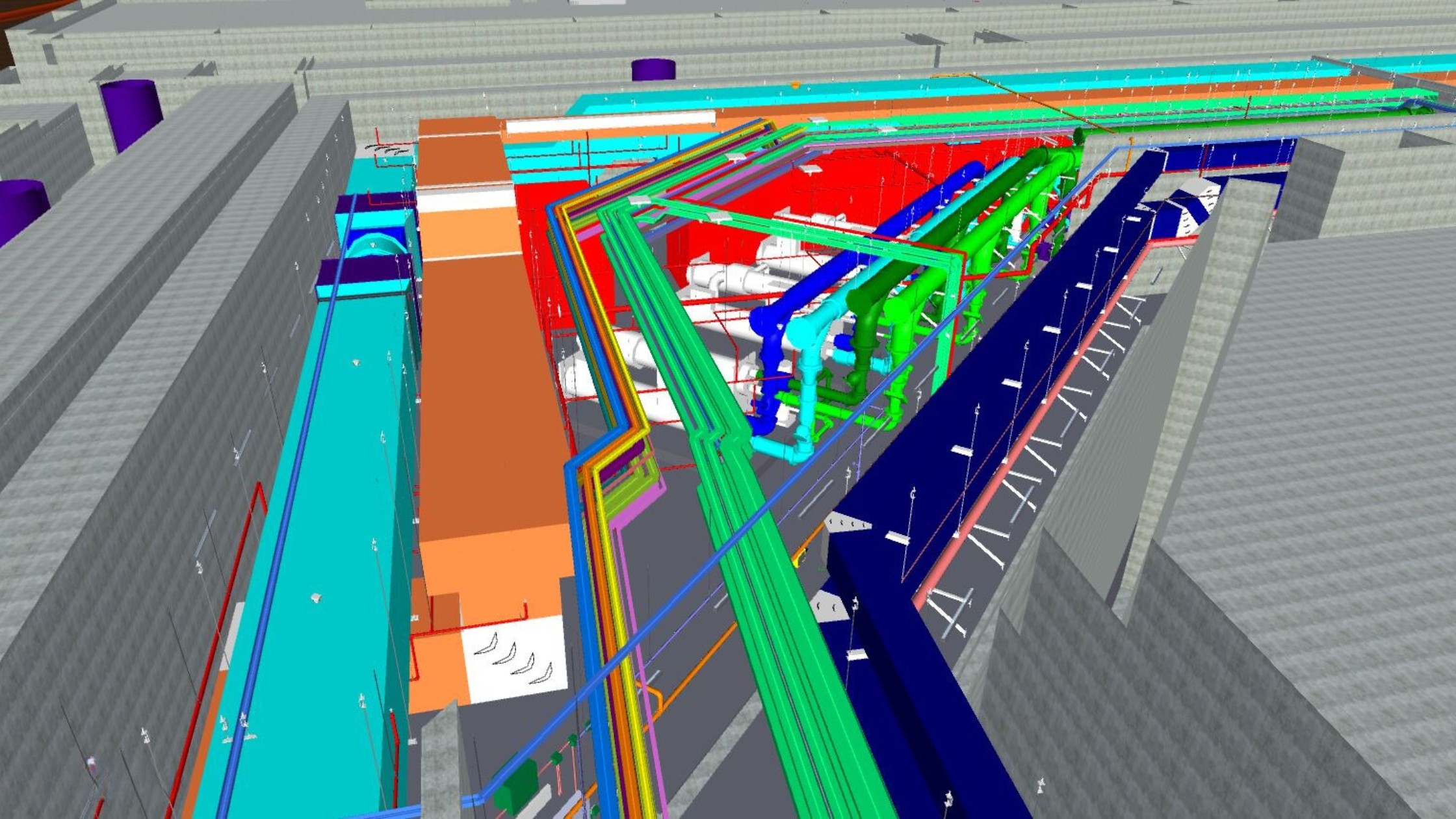 A man stands while two people sit at a table in an office setting, smiling and engaged in conversation. The mood is friendly and collaborative.